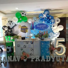 A unique combined theme party for a joint birthday celebration. I created a football theme for Pranav's 11th birthday and a Frozen theme for Pradyuta's 5th birthday, all in one cohesive setup.