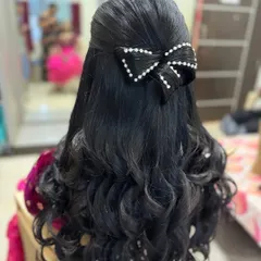 Another example of a hair bow, this time in black hair and accented with pearls. This shows how the sculptural technique can be adapted for different hair colors and textures.