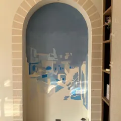 An early stage of the Santorini mural. The process starts with building up layers of color to create the foundation of the landscape before adding finer details.