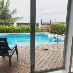 This view from inside the home looking out to the pool deck shows how the design encourages an indoor-outdoor lifestyle. The sliding glass doors can be opened completely to merge the two spaces.