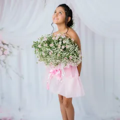 Looking up with a hopeful, dreamy expression. This pose adds a touch of magic to her portrait.
