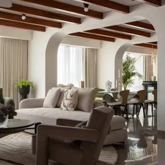 What dreams are made of. The glossy floor reflects the light and the carefully chosen furniture, including the geometric armchairs and soft sofa, creating a moody, eclectic, and deeply aesthetic living space.