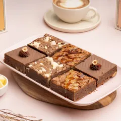 A platter showcasing my assortment of brownies. It includes the Dulce De Leche, Cookie Dough, and Chocolate Hazelnut varieties, offering something for every chocolate lover.