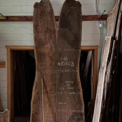 A pair of book-matched walnut slabs at the Nakashima workshop, waiting to be transformed into a masterpiece. This visit reaffirmed our belief in letting the natural beauty of the material guide the design.
