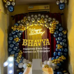 A classic balloon arch decoration for a first birthday at home. The blue, silver, and gold color scheme, along with the light-up name and number, creates a festive and personal touch.