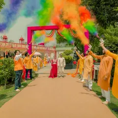 We believe wedding celebrations should be vibrant, energetic, and full of life. This grand entrance at a Haldi ceremony, with friends creating a tunnel of rainbow-colored smoke, perfectly captures the exhilarating joy and festive spirit of Indian weddings.