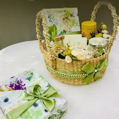 Experience the charm of eco-chic gifting with our beautifully arranged woven basket hamper. Adorned with a satin green bow and filled with curated goodies, this hamper is ideal for those who appreciate sustainable luxury and rustic elegance.