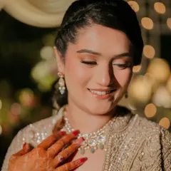 A candid smile from my bride Khushleen at her sangeet. The makeup is soft and glowing, with a focus on skin that looks radiant even in ambient evening light.
