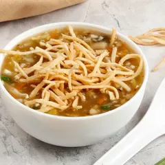 Our hot and sour Manchow Soup, a thick and flavourful soup filled with vegetables and topped with a handful of crunchy fried noodles.