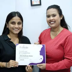Presenting the certificate of completion to a dedicated student. Her hard work in the class has paid off, and she is now fully equipped with professional skills.
