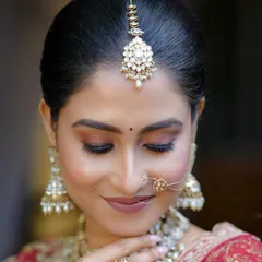A close-up of a stunning bridal look created for a photoshoot. The focus is on the flawless skin and the beautiful eye makeup.
