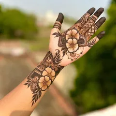 A stunning shaded floral design. The bold flowers on the wrist and palm are the centerpiece, showcasing advanced shading techniques that create a 3D effect.