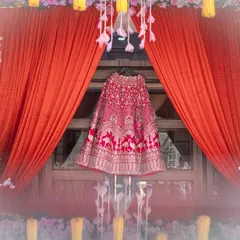 An artistic shot of the bridal lehenga, beautifully displayed against a window and framed by vibrant curtains. I see the dress not just as an outfit, but as a central character in the day's story.