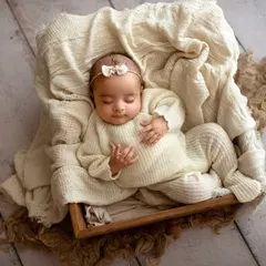 I believe in keeping things simple to let your baby's sweetness shine. This little one is sleeping peacefully in a cozy wooden box, nestled in soft, cream-colored knits, a perfect example of my safe and classic newborn photography style.