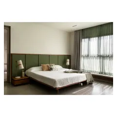 In this master bedroom, the grey terrazzo floor provides a cool, monolithic base for the custom teak bed and moss-green fabric headboard. The material choices are designed to create a feeling of tranquility and groundedness.