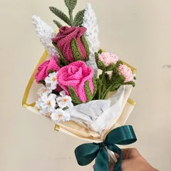 This romantic bouquet features two-toned pink crochet roses and smaller pink carnations, accented with white filler flowers. The soft colors and lush textures make it a perfect gift for someone special.