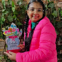 A teen student shows off her beautifully colored and assembled New Year calendar.
