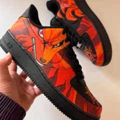 A view of the outer side of the Kurama AF1, showing the piercing red eyes and fierce expression of the Nine-Tails beast. The artwork is designed to flow across the panels of the shoe.
