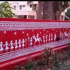 A section of the Warli mural depicting a procession with figures on horseback. Each element is hand-painted to honor the traditional style, adding a sense of movement and celebration to the home's exterior.