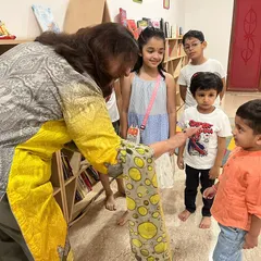 A sweet moment during our Ganesh Chaturthi celebration, where an instructor interacts with the children, making them feel special and included.
