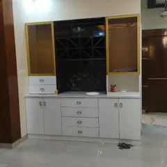 This custom-built crockery unit features a mix of closed cabinets, drawers, and fluted glass shutters with a metallic finish. It also includes a built-in wine rack, demonstrating how I combine storage, style, and specific client needs into one piece of furniture.