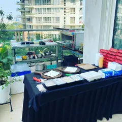 We can set up a complete live pizza station anywhere, even on a high-rise balcony. This image shows our compact and efficient setup for a private birthday party, complete with a professional oven and all necessary ingredients.