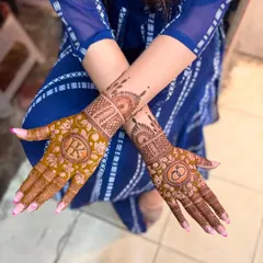 A beautiful floral design for an engagement, with the couple's initials 'RK' on one hand and the ring symbol on the other.