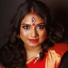 A direct and captivating portrait from the Devi shoot. This close-up highlights the clean lines of the eye makeup and the precise detail of the forehead art, set against a flawless, glowing complexion.