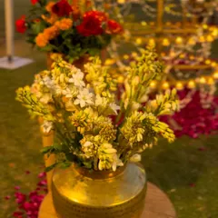 A traditional brass pot filled with fresh tuberoses, a simple yet elegant detail that adds a touch of heritage to any decor.