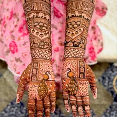 A grand bridal design featuring majestic peacocks on the palms and traditional motifs like elephants and temple domes on the forearms.