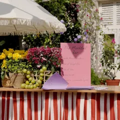 A detail from the Spanish-themed Haldi. We set up a mocktail bar with a vibrant red and white striped base, topped with fresh fruits and flowers, adding to the Mediterranean market feel.
