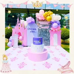 For this outdoor princess party, we built a beautiful pink castle backdrop under the open sky. The "Once upon a time" theme is brought to life with pastel balloon clouds and a custom printed floor, creating a perfect royal setting.