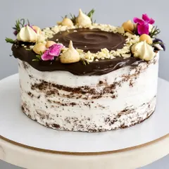 For those who like their cake bold and nutty, my Chocolate Hazelnut Naked Cake is unforgettable. It features a decadent chocolate sponge, dark chocolate ganache, Nutella, and a topping of roasted hazelnuts and almonds.