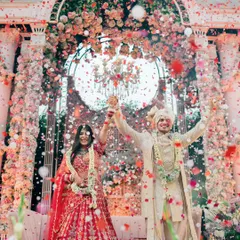 A moment of pure celebration. The explosion of confetti and flowers during the varmala is more than just a picture; it's the feeling of two families becoming one, frozen in time.