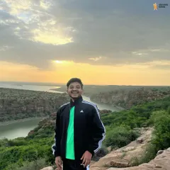 A solo traveler soaking in the golden hour at Gandikota. It's a place that makes you feel small in the face of nature's grandeur.
