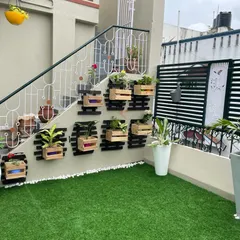 We designed this custom planter wall to fit neatly under a staircase on a terrace. The wooden box planters add a rustic touch and utilize an often-overlooked space for adding plants and color.