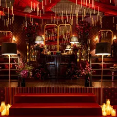 We transform spaces into dramatic, immersive worlds. This event featured a rich, red-on-red palette, with floating candles suspended from the ceiling and opulent floral arrangements to create a moody, theatrical, and utterly romantic ambiance.