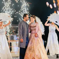 A grand entrance for a grand celebration. The couple's coordinated looks, with her sparkling lehenga and his elegant bandhgala, were designed to make a statement and set the tone for a magical Sangeet night.