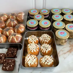 An assortment of treats ready to be packed into our Diwali hampers. This image shows our popular Korean buns, jar desserts, and brownies, all freshly baked and ready for gifting.
