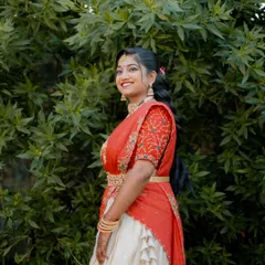 Radiant and glowing! My cherished client Harshitha dazzles on her engagement day in this custom-made red and ivory half saree that I crafted for her in under a week. She looks absolutely stunning.