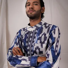 A powerful portrait with crossed arms that exudes confidence. This shot is perfect for a lookbook, showcasing the bold, geometric print of this modern kurta with a sharp and direct feel.