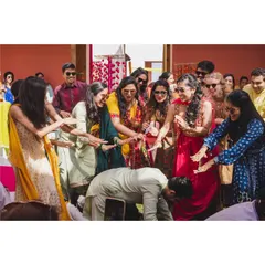 A playful moment captured during the group dance where the bride's squad showers the groom with love. It’s these fun interactions within the choreography that create lasting, happy memories.