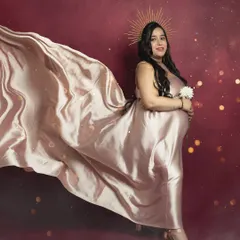 This champagne satin gown has a beautiful shimmer. Here, I've tossed the fabric to create a dramatic wing-like effect, perfect for an ethereal and glamorous portrait.
