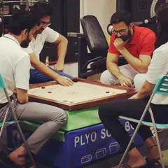 Taking a short break for a game of carrom. We believe that finding moments for play and relaxation helps our team stay energized and focused.