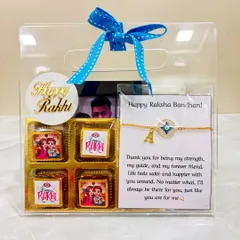 This Rakhi hamper for a brother is beautifully packed in a clear bag with a blue ribbon. It contains a personalized rakhi with his initial, a photo, and festive chocolates.