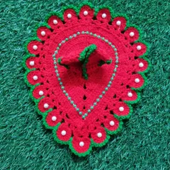 A simple yet beautiful red woolen poshak with a green border and white pearl details. This design is shaped like a leaf or paan, offering a unique look for Bal Gopal.