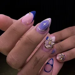 A stunning example of Korean-inspired nail art, this set features a delicate 3D flower, gold starbursts, and abstract color blocking. Each nail is a different piece of art.