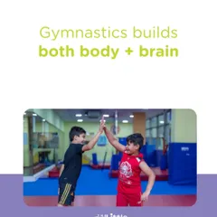 Gymnastics builds both body and brain. This image of two boys high-fiving captures the social and physical rewards of our program, where every activity is designed for holistic development.