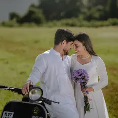 An intimate close-up of the couple with their scooter, sharing a quiet moment. The purple flowers add a soft, romantic detail.