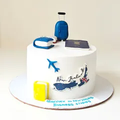 A "Good Luck" cake for someone moving to New Zealand for business studies. The design features a fondant passport, suitcase, and a map of New Zealand.